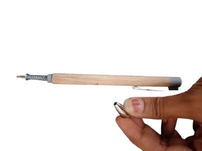 A wooden click pen opened to show the spring and click part