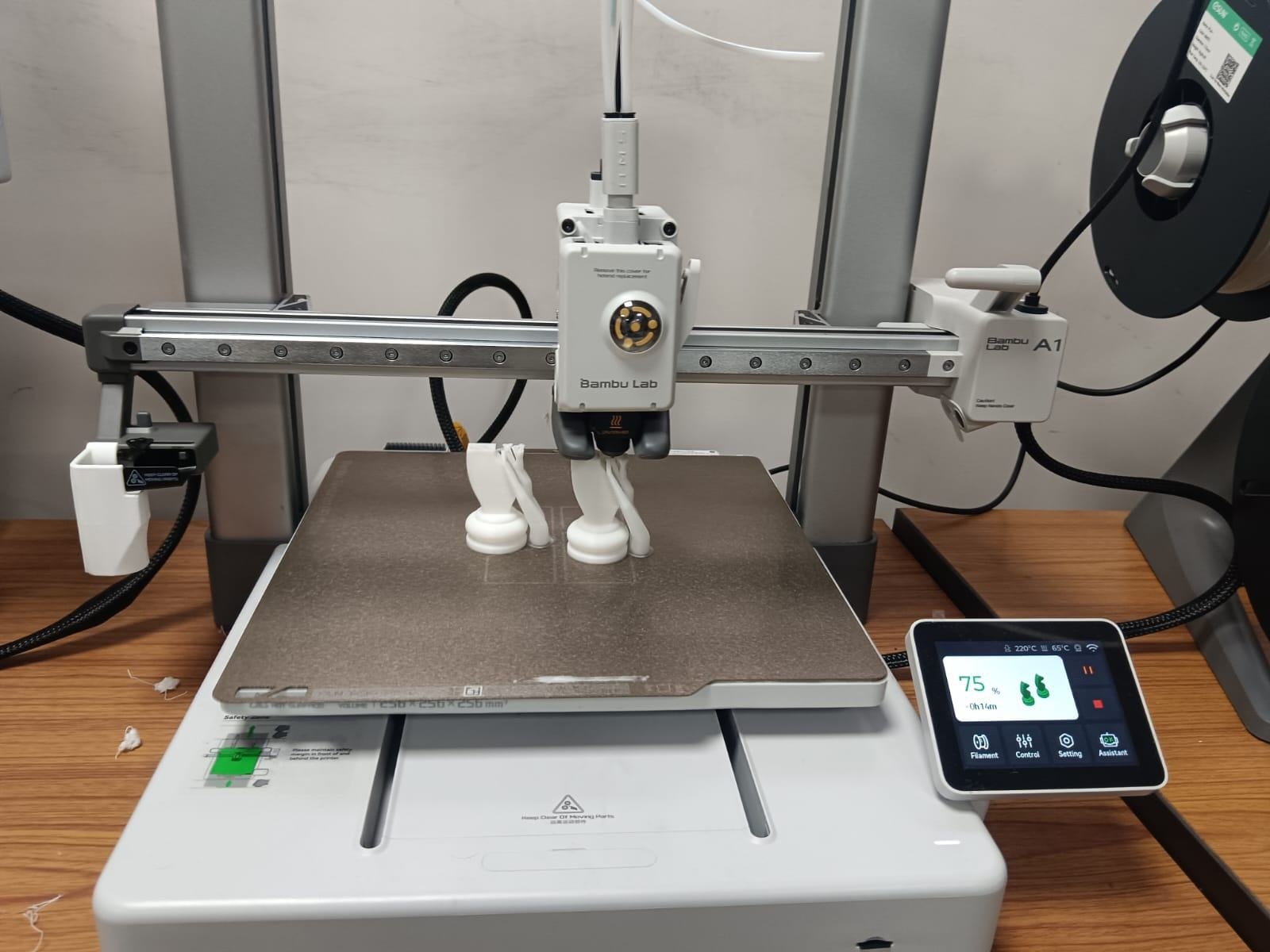 The printer bed with the knight partway through the print