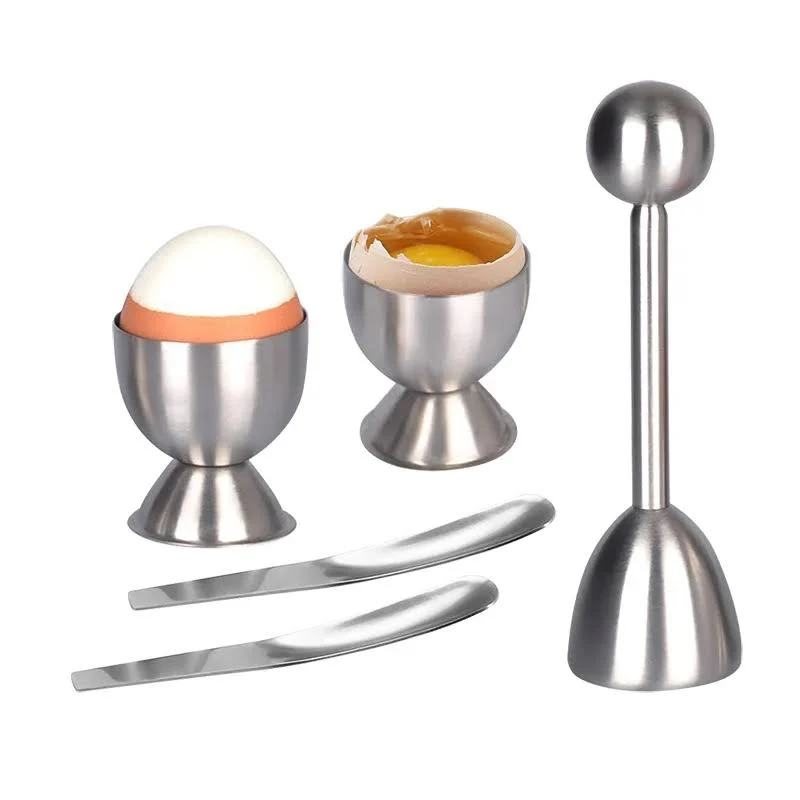 Steel egg cups, spoons and a spring-loaded egg topper
