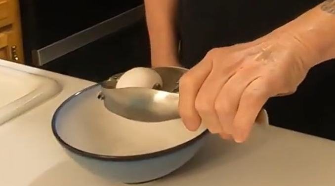 A hand pressing a metal clamp over a bowl