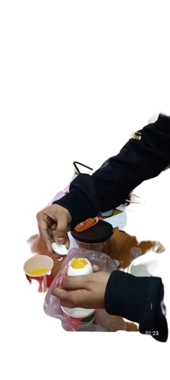 The egg with its top removed and the yolk intact