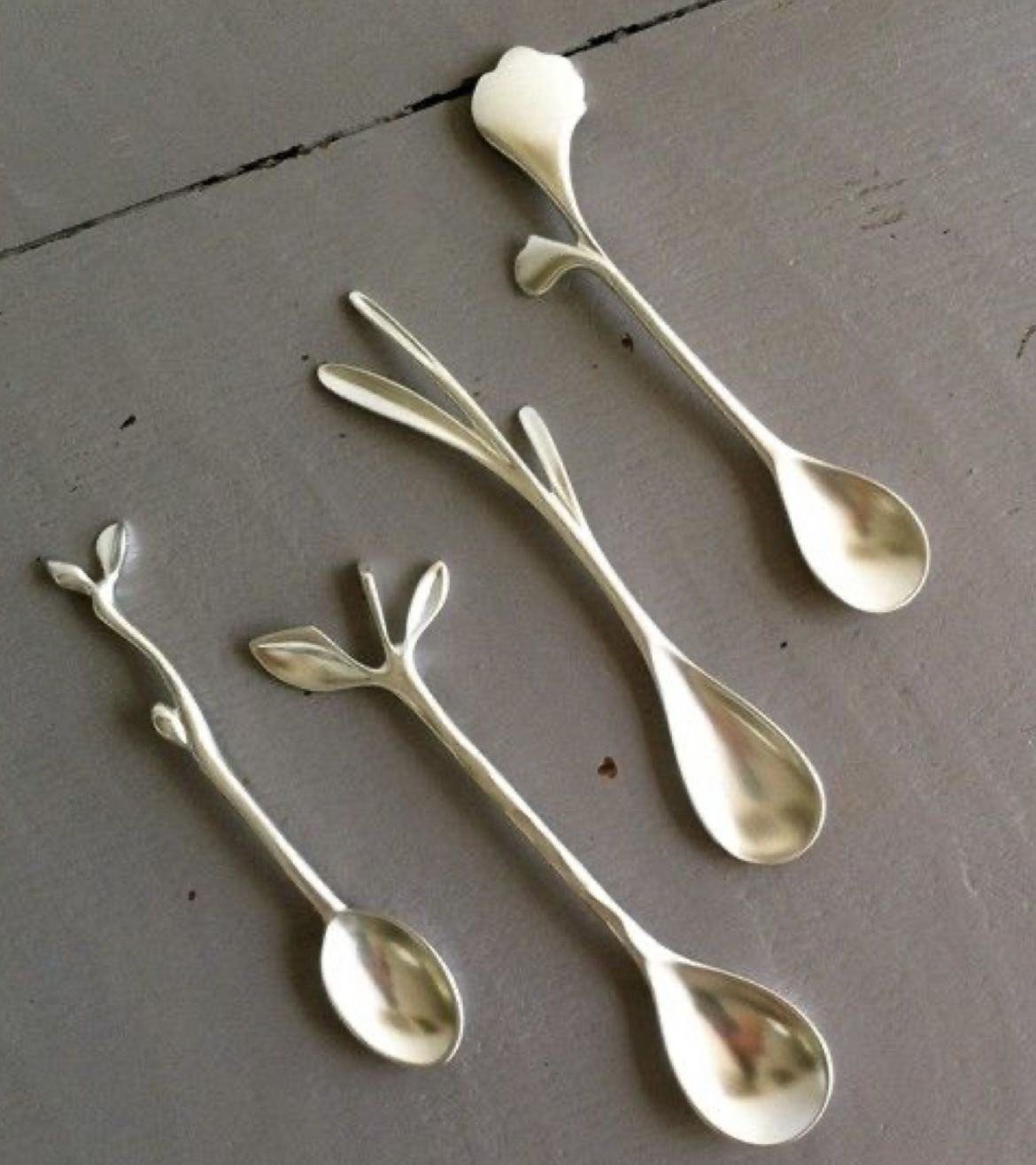 Gold-toned spoons with leaf-shaped handles