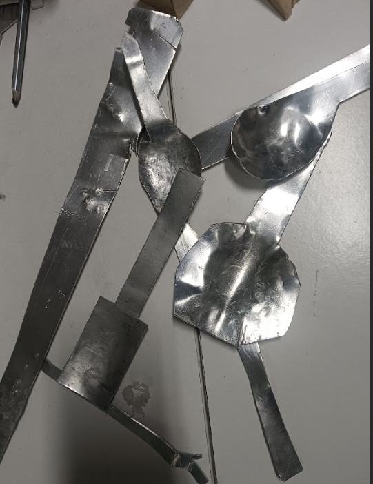Aluminium spoon bowls and strips on a table