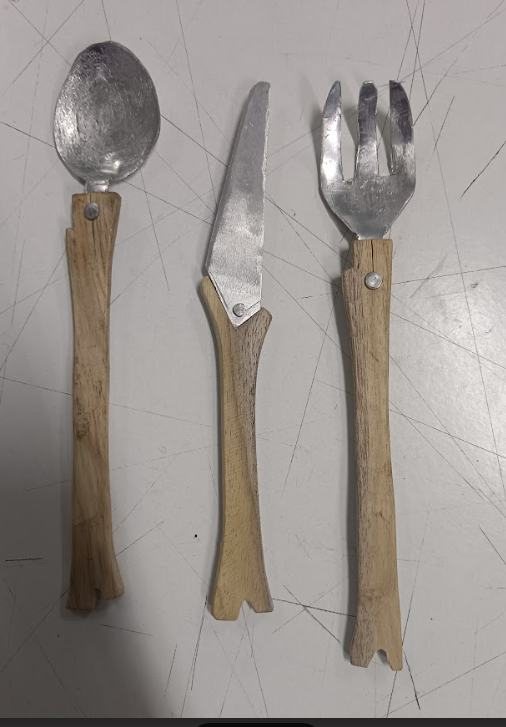 The finished spoon, knife and fork with wooden handles