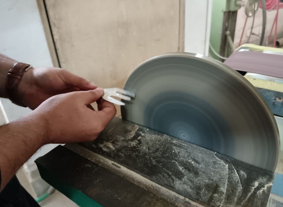 Grinding a fork head against a wheel