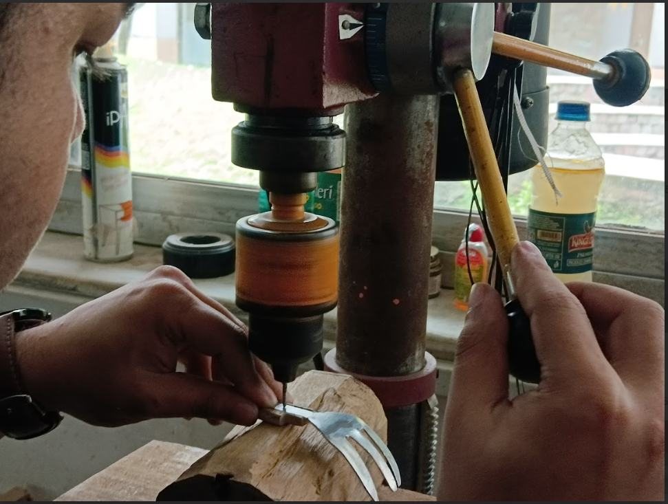 Drilling a rivet hole in a handle