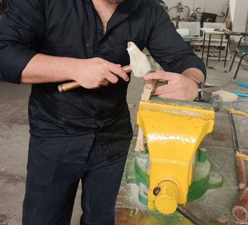 Shaping a handle held in a yellow vice