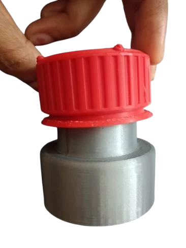The red cap being pressed on the silver bottle body