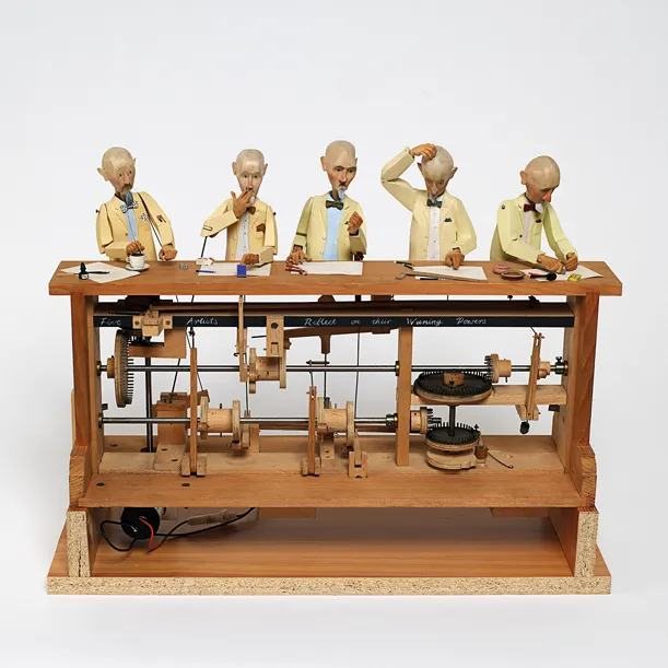 A traditional wooden automaton with a row of seated figures driven by a cam shaft
