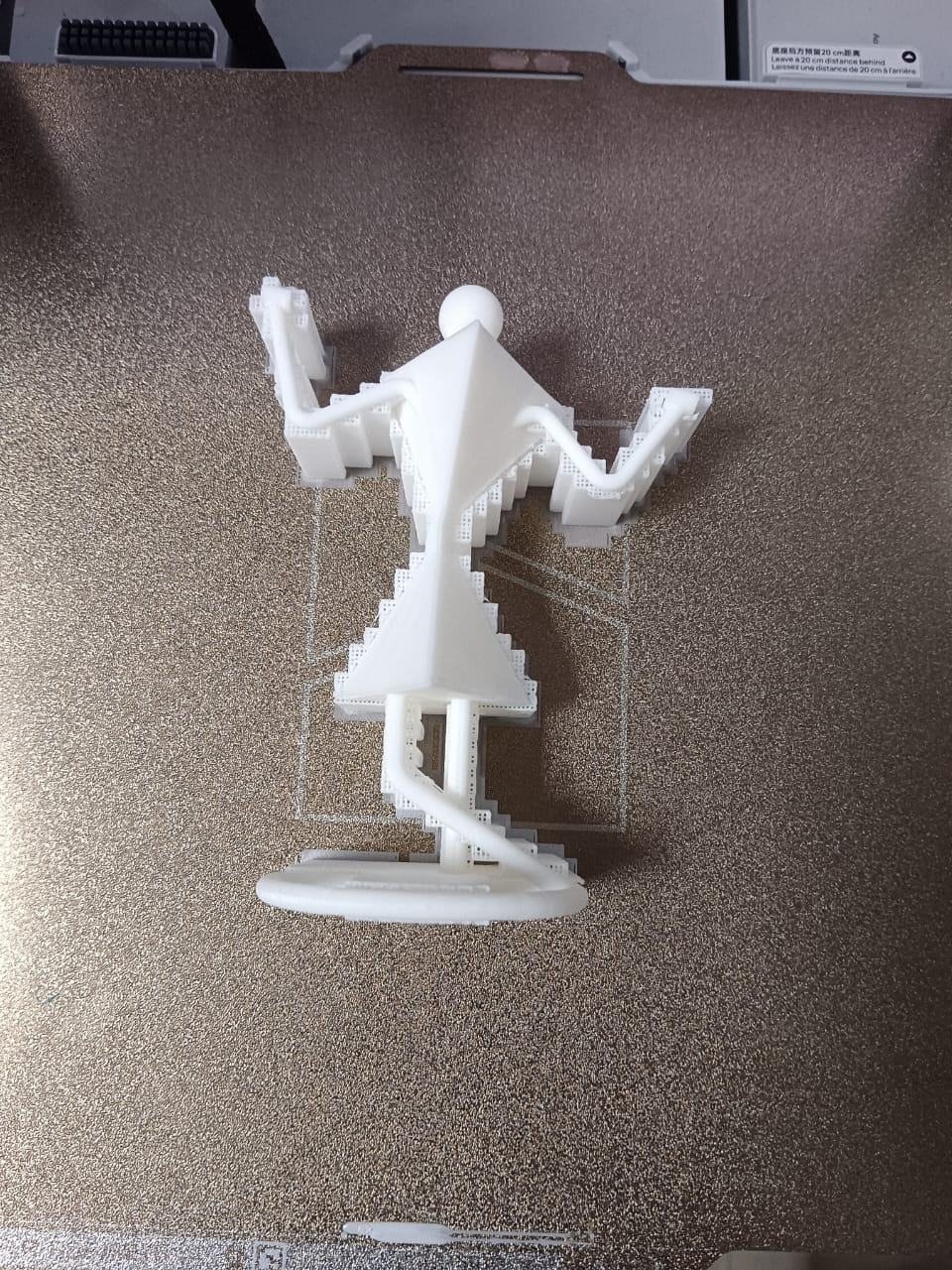The figure partly printed on the bed with its support structure